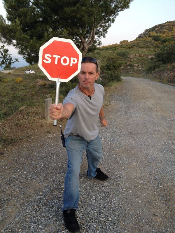 On-set with stop sign, coastal gravel road, Spain