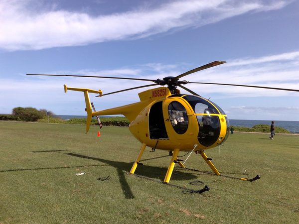 Aerial camera helicopter on standby, oceanfront, Hawaii