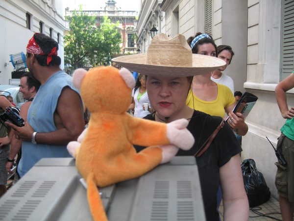 Crew on location street with sombrero hat and monkey puppet prop, Brazil