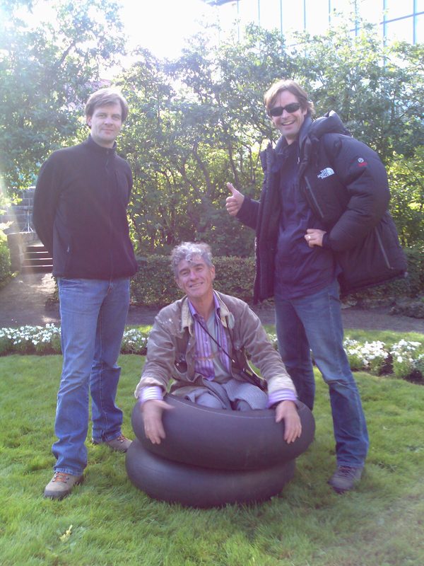 Crew posing with inflatable tire props in a garden, Iceland