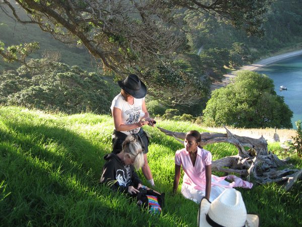 Wardrobe fitting on grassy hillside overlooking the coast, North Island