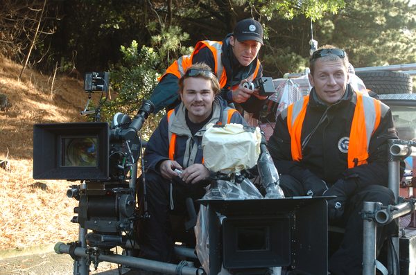 Crew posing with ARRI camera rig on vehicle mount, New Zealand
