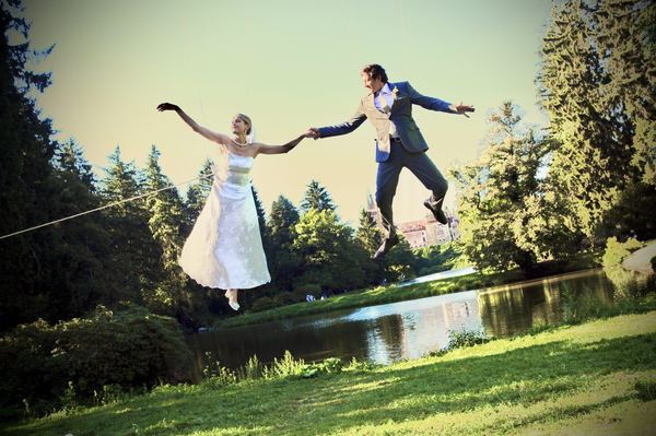 Bride and groom suspended on wire rig, Prague