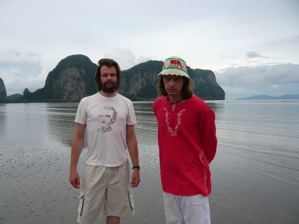 Dir. Arni and Kinski standing on a beach with limestone karst islands, Thailand