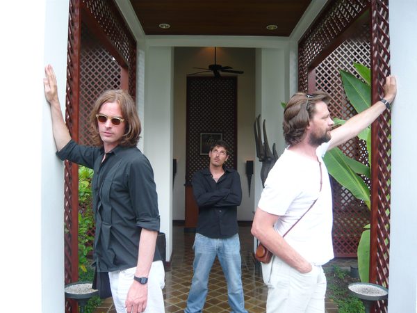 Three crew members posing in a resort doorway, Thailand