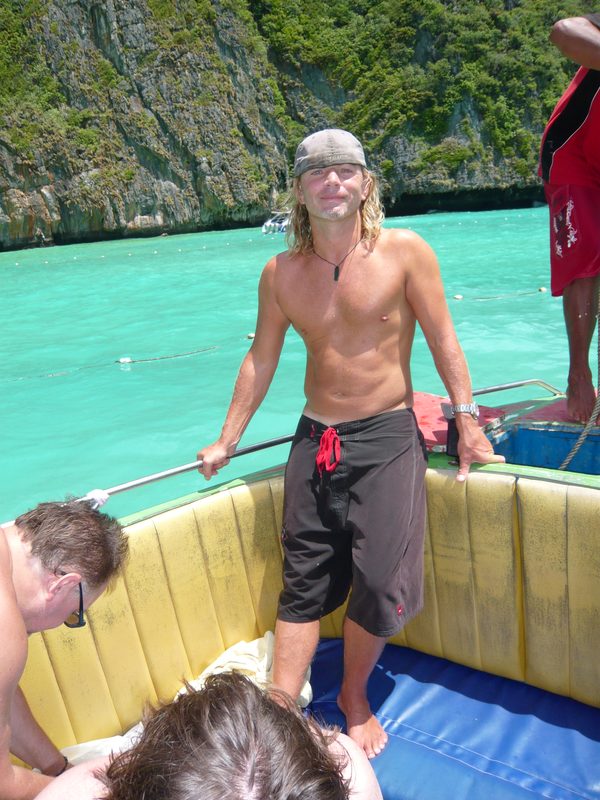 Crew member on the boat near limestone karst islands, Thailand