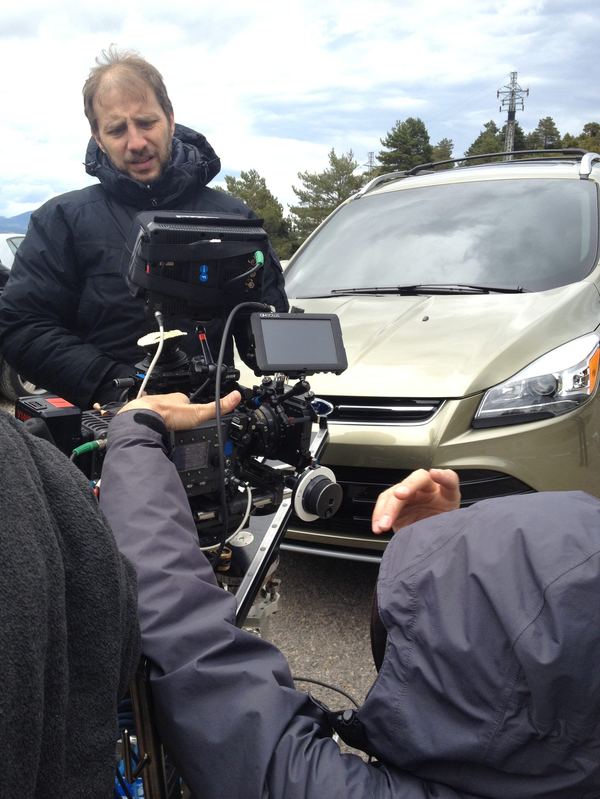 Camera crew setting up shot with Ford vehicle, Spain