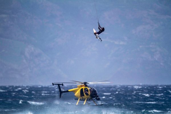 Kitesurfer launching high above a camera helicopter, Hawaii