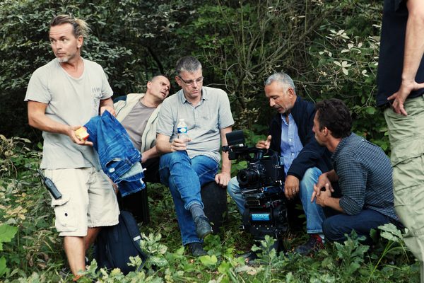 Crew gathered around a Canon camera rig in the woods, Prague
