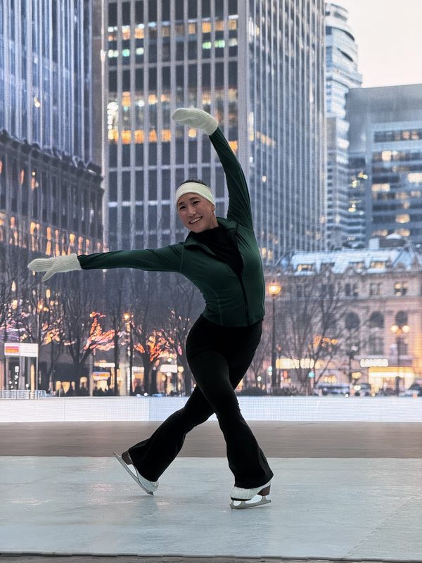 Figure skater performing on an LED volume stage with a city backdrop, Los Angeles