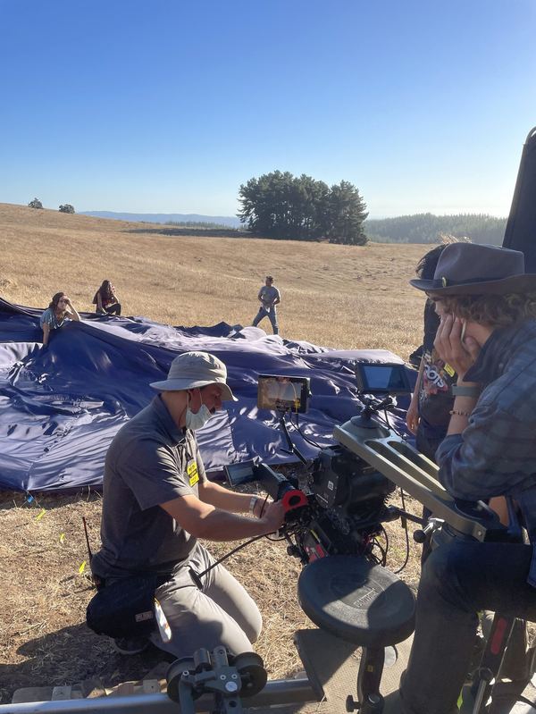 Camera crew on dolly track, open field, Chile