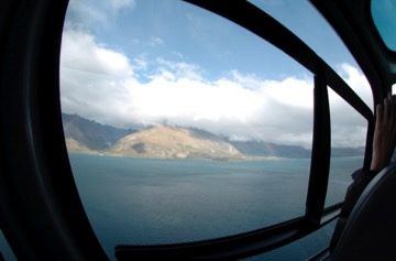 View from helicopter cabin over lake, New Zealand