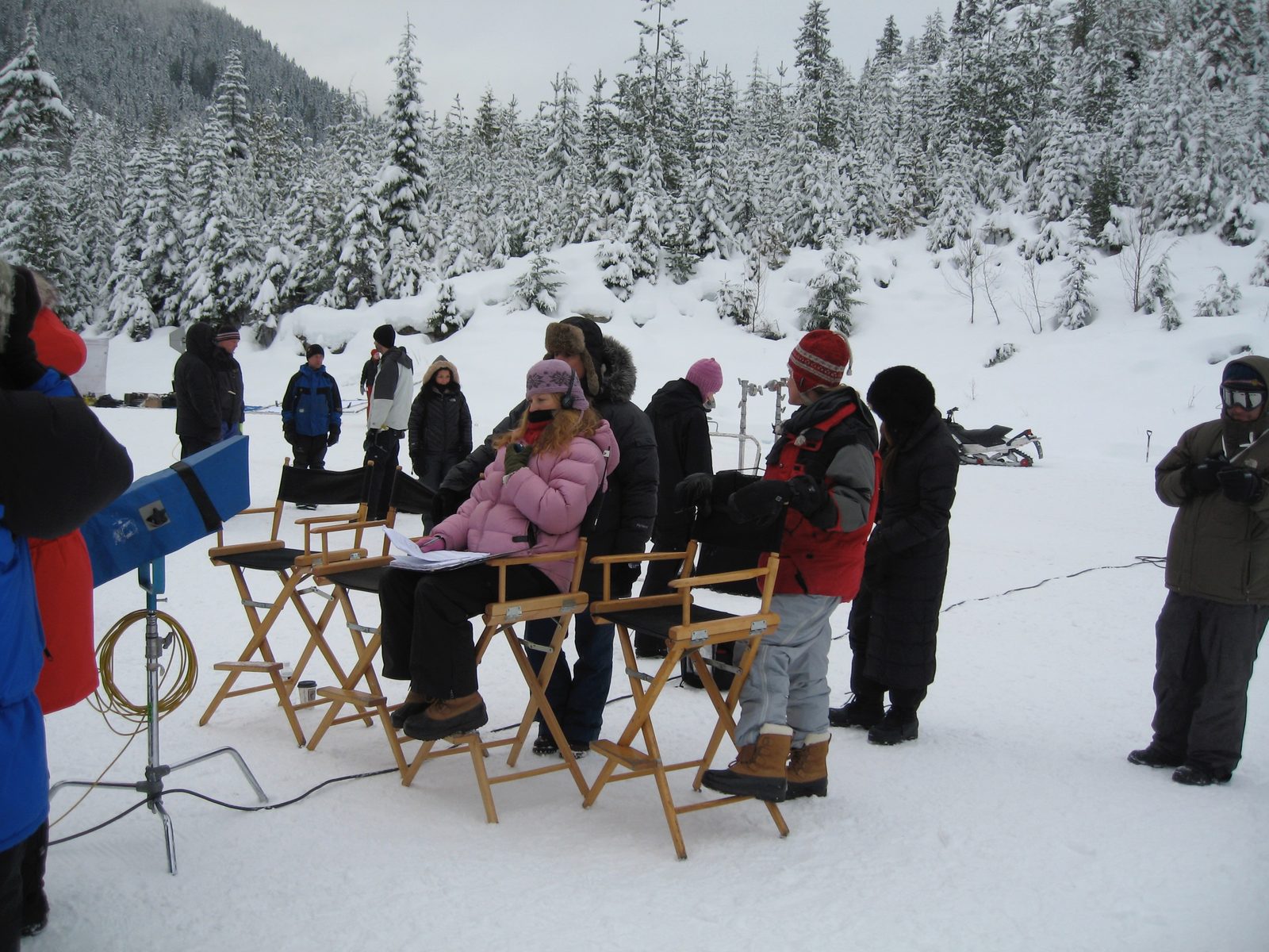 Director's chairs and crew on snowy set, Canada