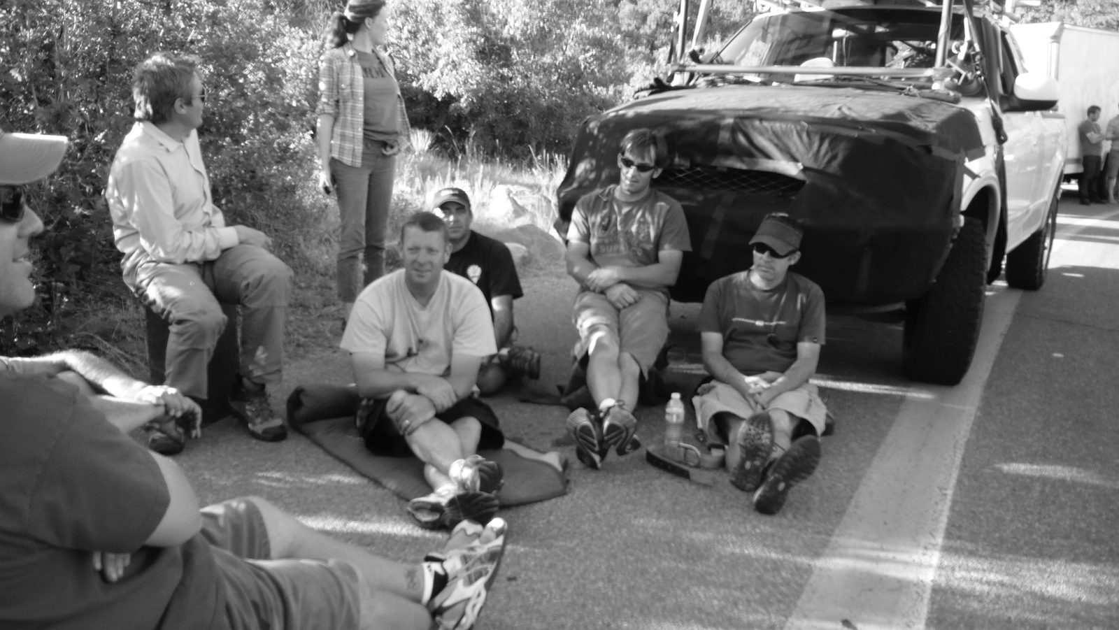 Crew resting by camera vehicle on location, Colorado