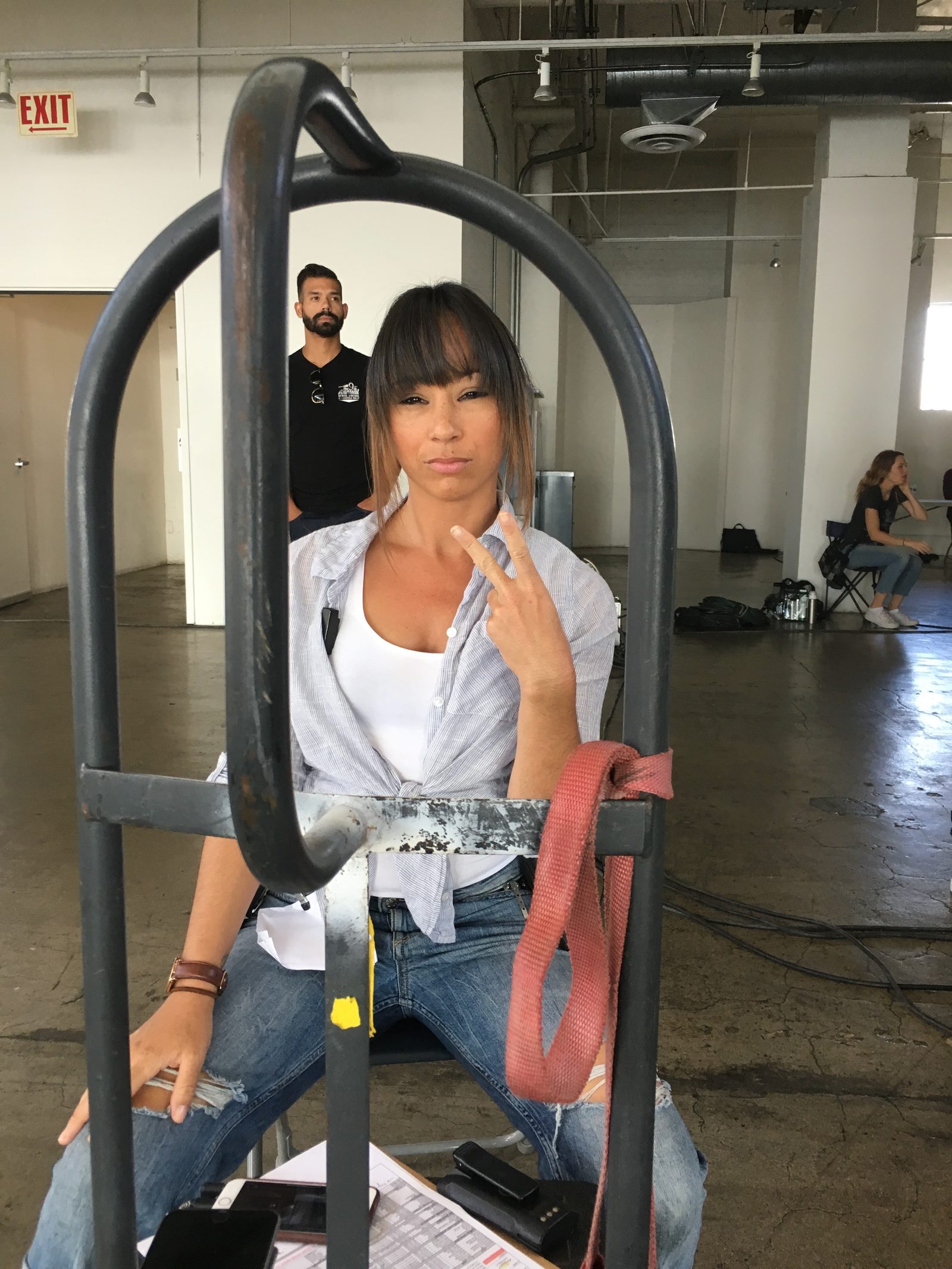 Crew portrait behind luggage cart on set, Los Angeles