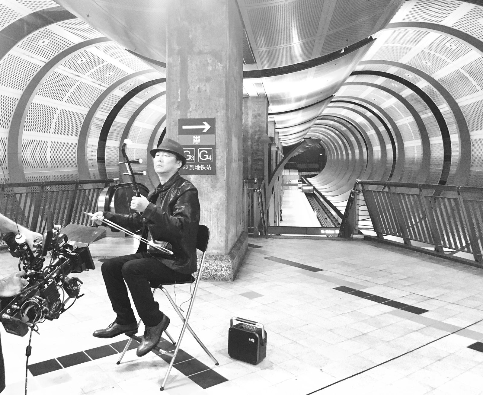 Musician playing erhu in subway station, Los Angeles